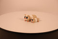 Large and small tan and white articulated 3D‑printed guinea pig desk pets, fidget toys.